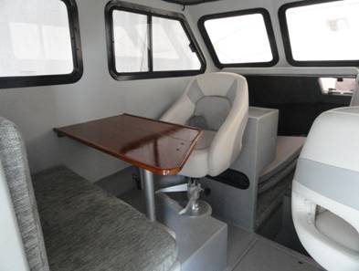 Passenger side helm seat facing the dinette table